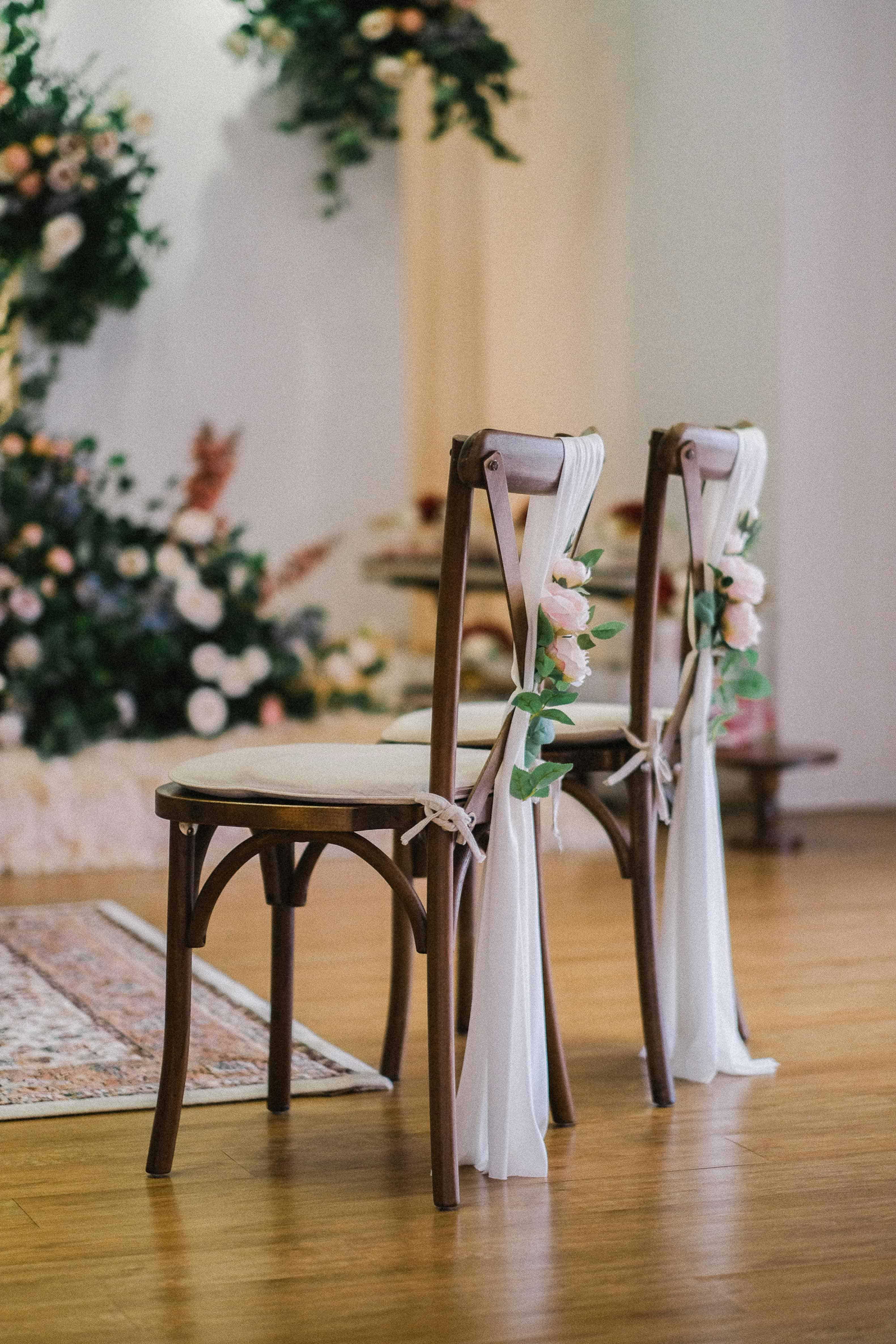 Burgundy, green and white flower table centre suspended above a table.